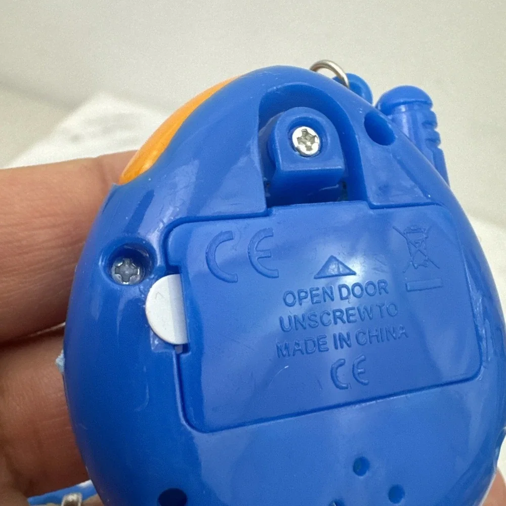 2 Collectors Tamagotchi With Crack On Plastic On Right Side Still Works